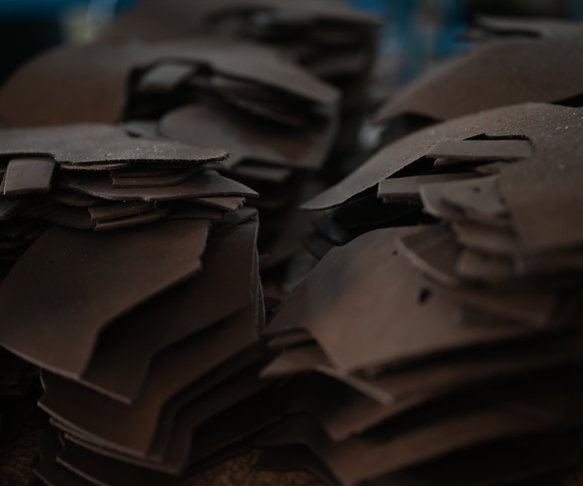 Cut leather and textile components prepared for stitched shoe upper production